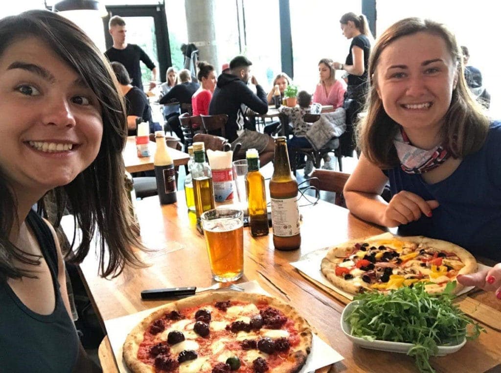Maja i Tamara jedzą pizzę w knajpie